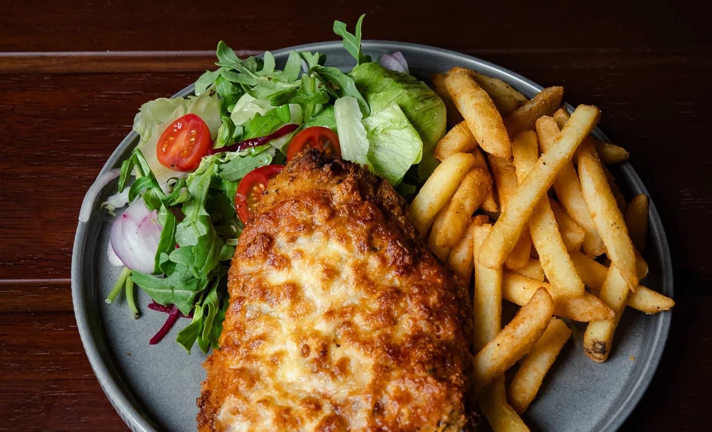 The Old Forge chicken parmi with chips and garden salad